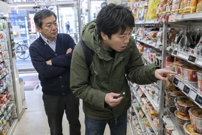 Digital price tags in a Shibuya convenience store; a purchaser examines a USB drive found with pricing logs, 14 September 2026.