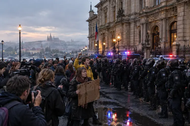 Protesters and police outside the Chamber of Deputies in Prague on Monday evening after the Šála Ledger leak; officers form a line by the parliamentary fence.