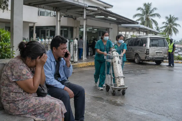 Relatives and staff outside Lomal General Hospital, capital of Tanua, on Monday as wards fill and supplies run low.