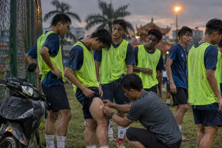 Young players in Ho Chi Minh City prepare with the adhesive 'FlexPatch' before a training match. The device has been linked to sudden gains in sprint and recovery data.