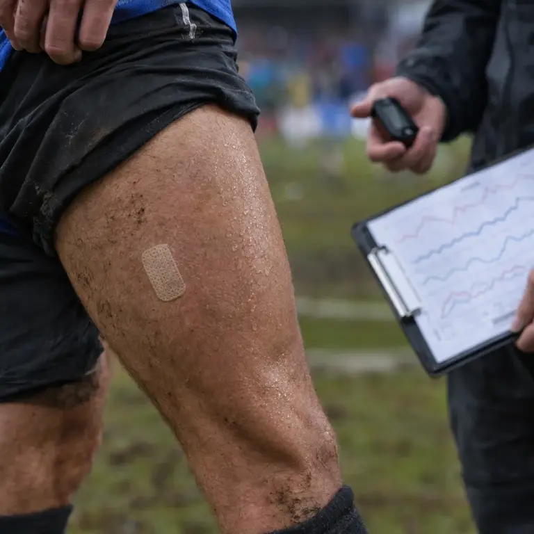 Detail: the FlexPatch adhered to a player's thigh at a district training ground in Bà Rịa–Vũng Tàu.